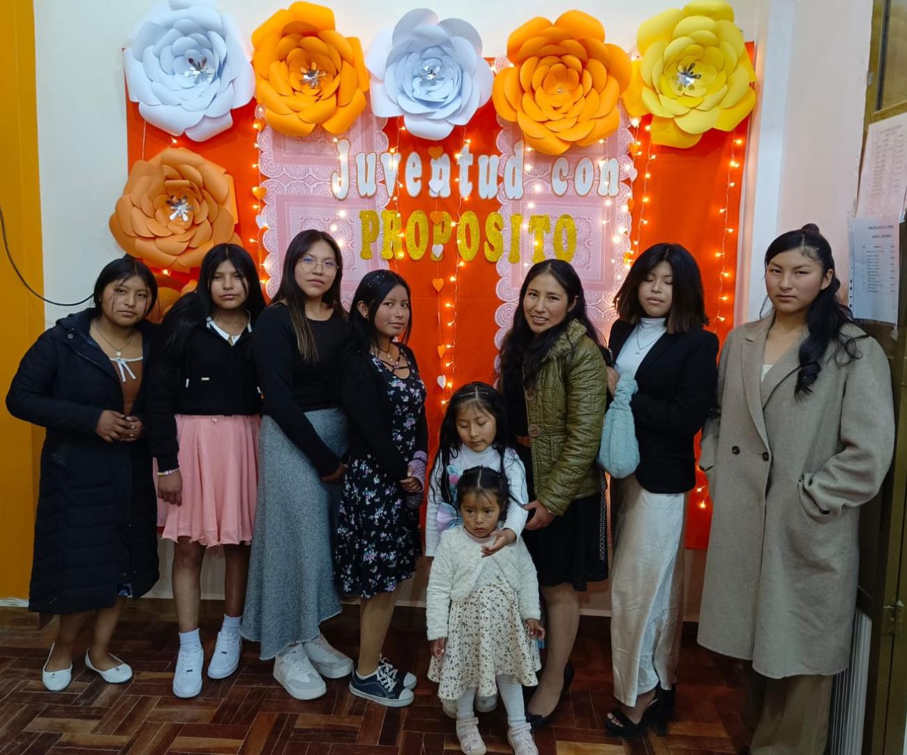 Tutors and young ladies taking a memory photo.